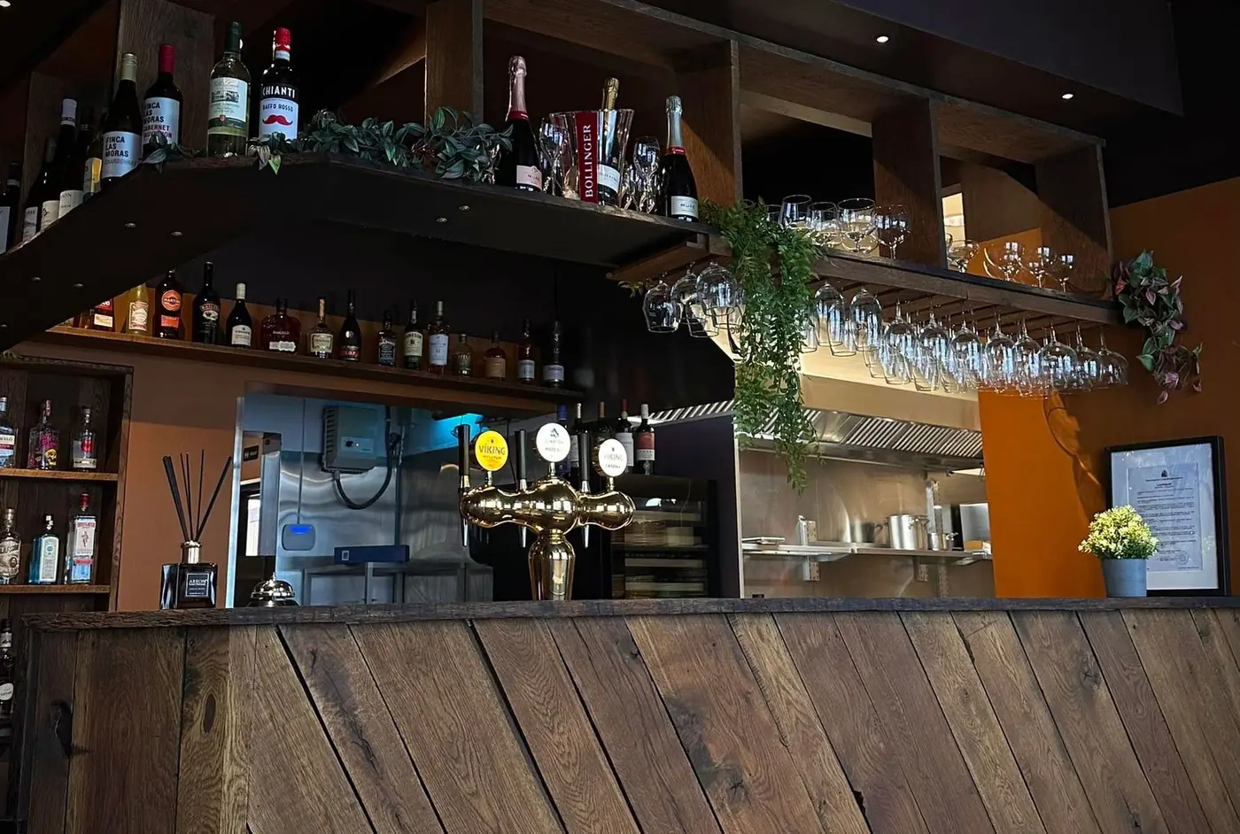 The bar at Fish House, built from reclaimed timber, with wine racks and beer taps behind it