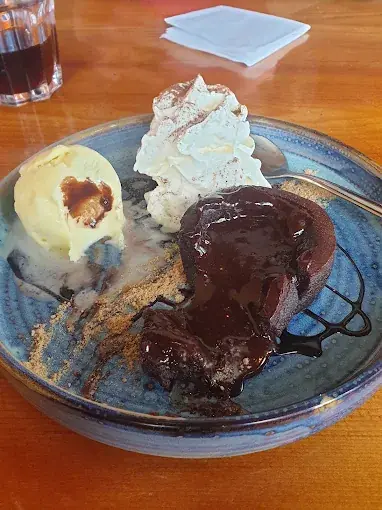 A chocolate dessert with ice cream